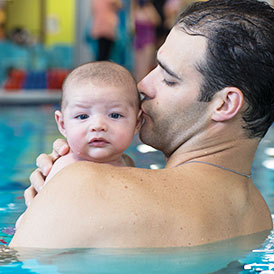 A Dad and his child enjoying a swim lesson for infants and Goldfish Swim School